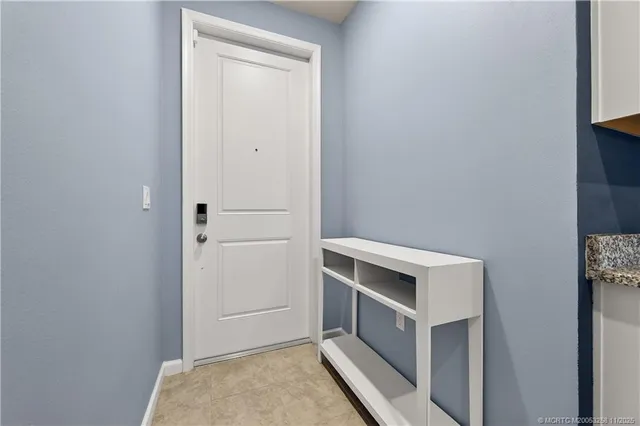 a large white kitchen with a large window