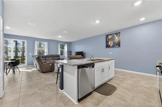 a living room with furniture and kitchen view