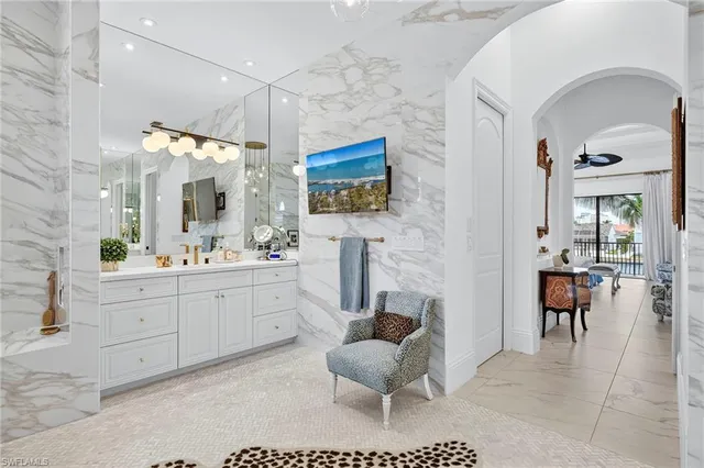 a spacious bathroom with a sink and a mirror