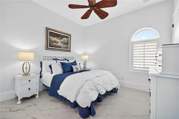 a bedroom with bed and window