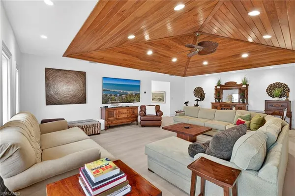 a living room with furniture and a ceiling fan