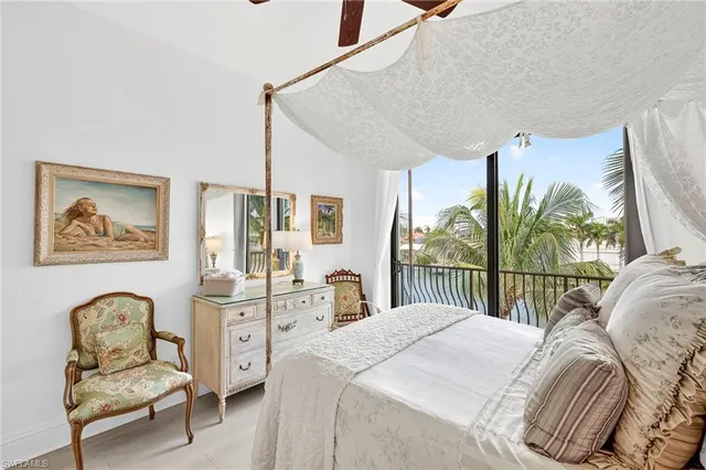 a bedroom with a bed and a large window with outer view