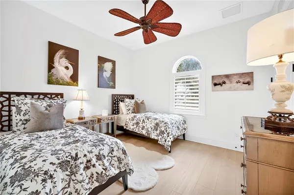 a bedroom with two beds and a window