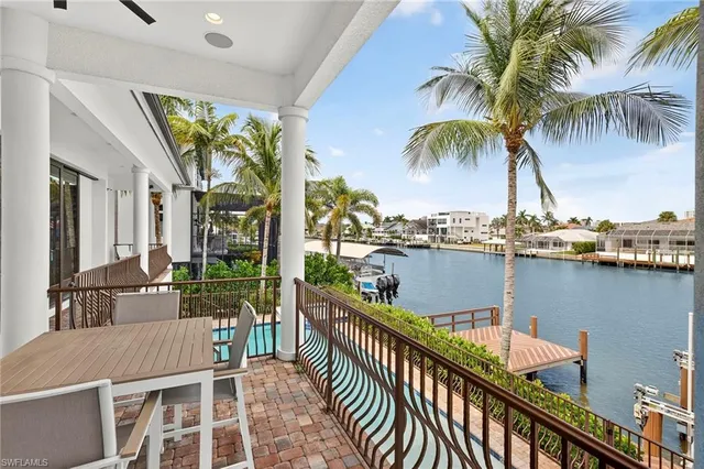 a balcony with tall trees in front of it