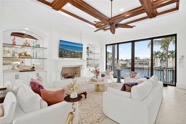 a living room with furniture fireplace and a large window