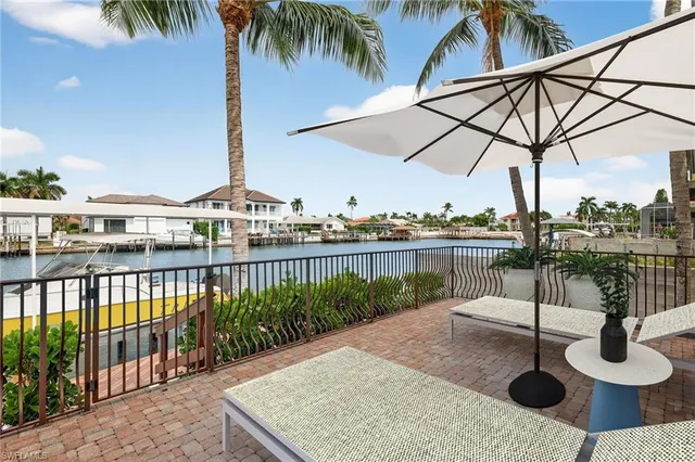 a view of a swimming pool with a chair and tables
