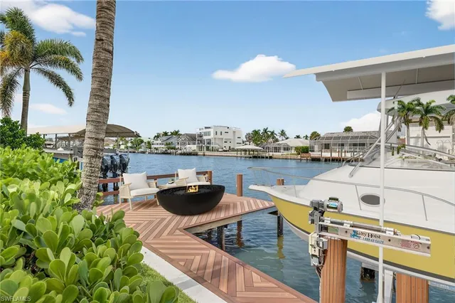 a view of a swimming pool with outdoor seating and plants