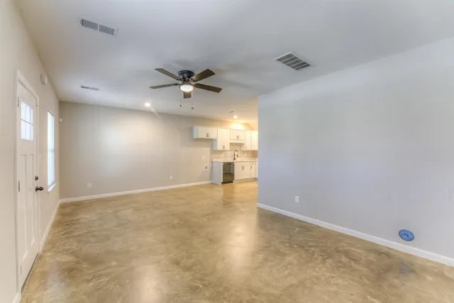 an empty room with a empty space and a ceiling fan