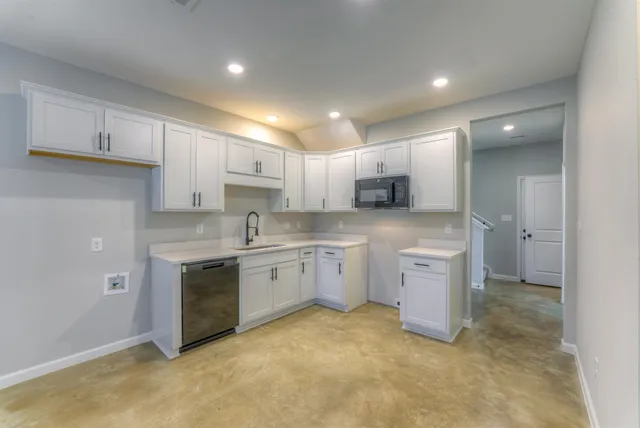 a kitchen with a sink stove and cabinets