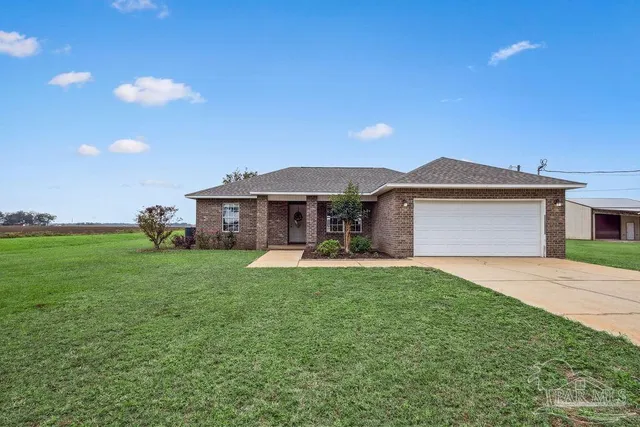 a front view of a house with a garden and porch