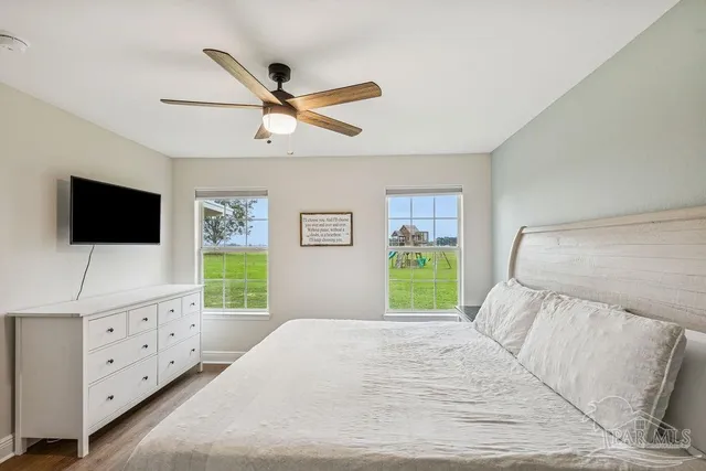 a bedroom with a bed and a flat screen tv