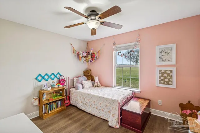 a bedroom with furniture and a large window