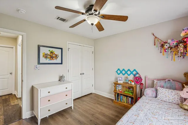 a bedroom with furniture and a wooden floor