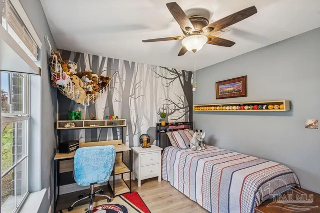 a bedroom with furniture and a window