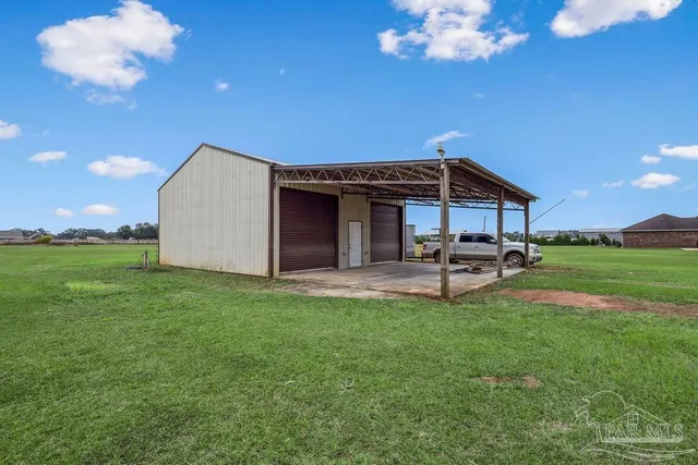 a view of a house with backyard and sitting area