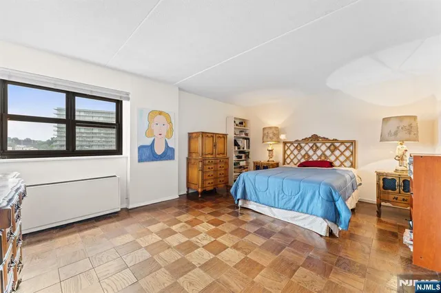 a bedroom with a bed and a book shelf