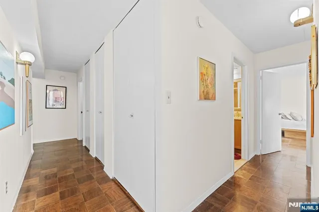 a bathroom with a granite countertop sink a toilet and mirror