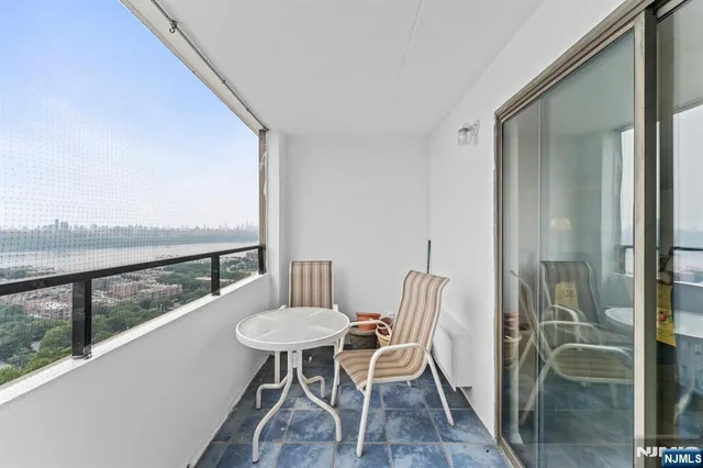 a view of a balcony dining table and chairs