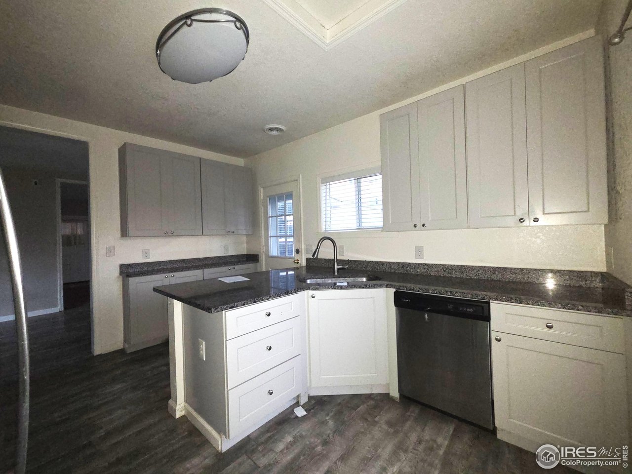523 Chestnut Street Sterling, CO 80751 - Photo 5 of 13 a kitchen with granite countertop a sink and cabinets