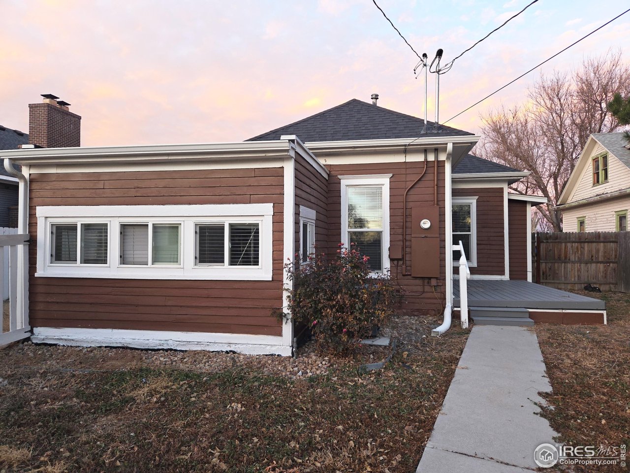 523 Chestnut Street Sterling, CO 80751 - Photo 10 of 13 a front view of a house with a yard