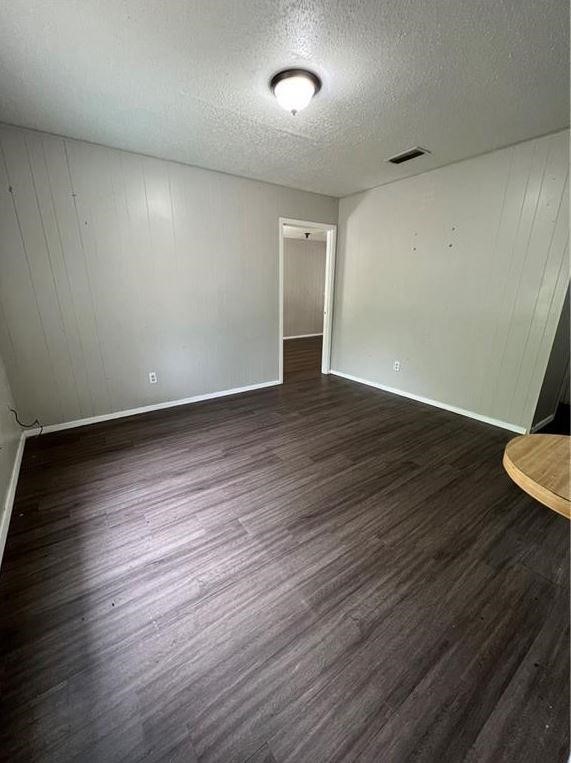 202 Hinton Street, Unit G George West, TX 78022 - Photo 2 of 6 an empty room with wooden floor and windows
