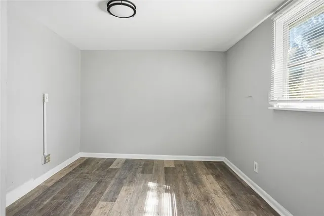 a view of a room with wooden floor and fan