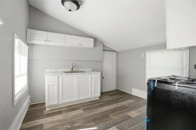 a utility room with cabinets washer and dryer
