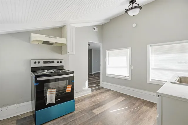 a kitchen with a stove and a microwave