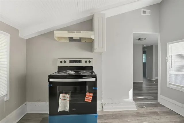 a kitchen with granite countertop a stove and a sink