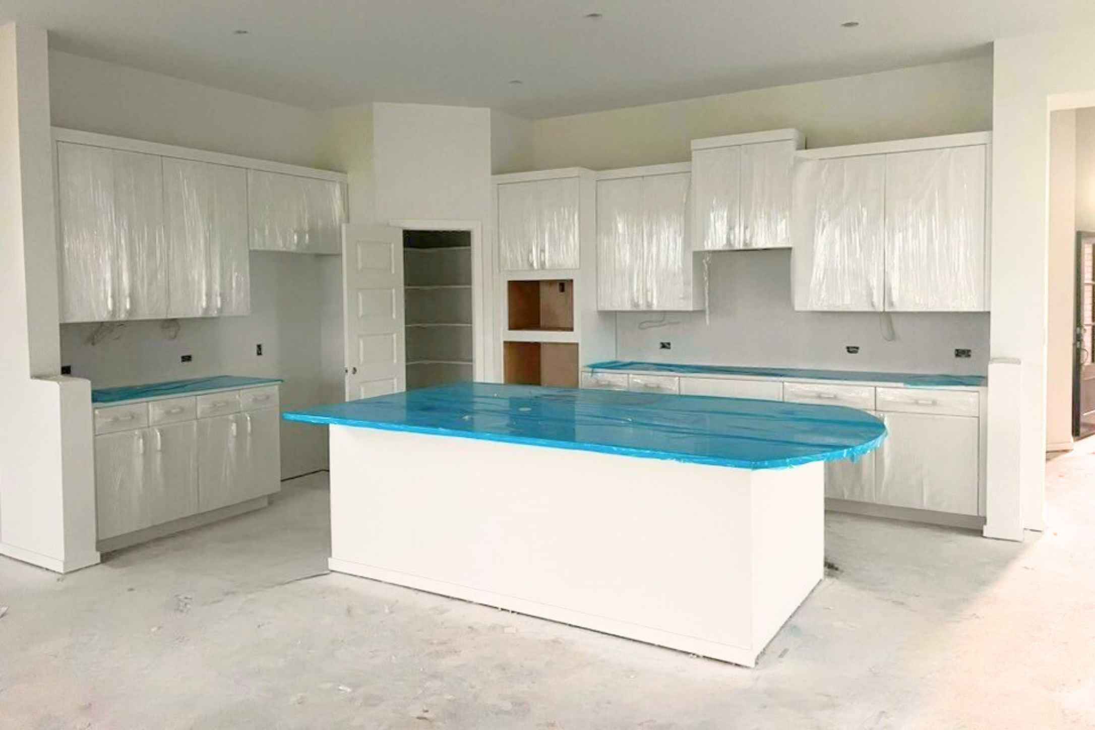 140 Pipe Cactus Pass Georgetown, TX 78633 - Photo 3 of 31 Kitchen with a kitchen island, concrete flooring, and white cabinets