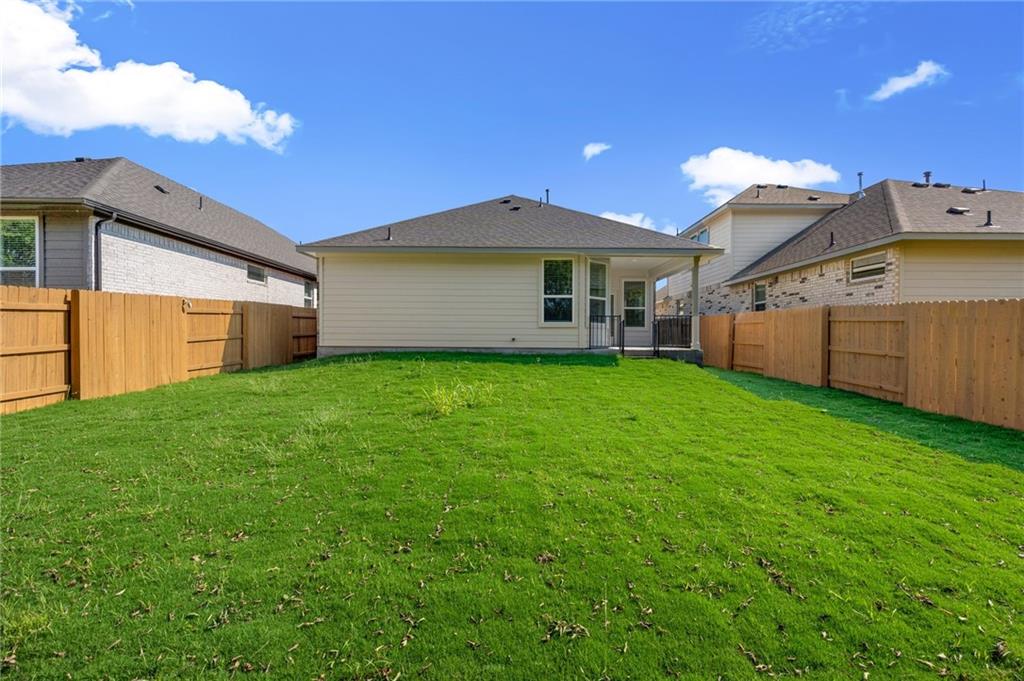 1012 Paddock Lane Georgetown, TX 78626 - Photo 11 of 15 A well-maintained lawn surrounds the property, offering ample space for outdoor enjoyment.