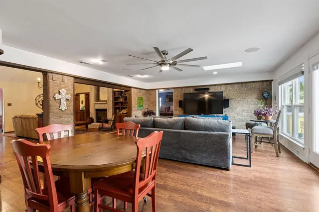 a living room with furniture a chandelier and a large window