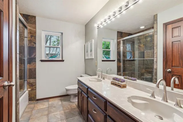 a bathroom with a sink double vanity and a shower
