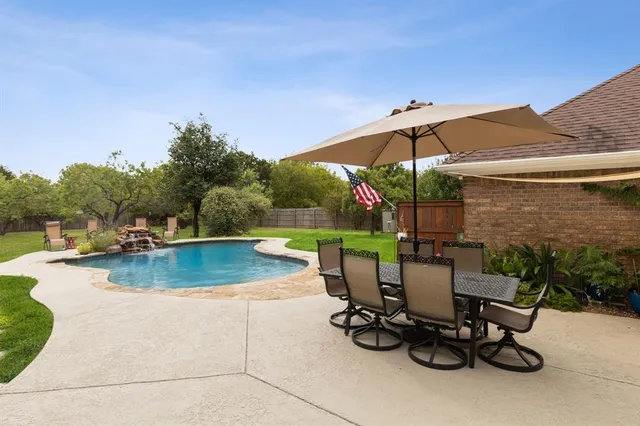 a view of a swimming pool with a patio