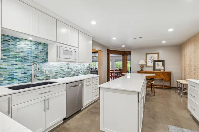 a kitchen with sink attached with living room