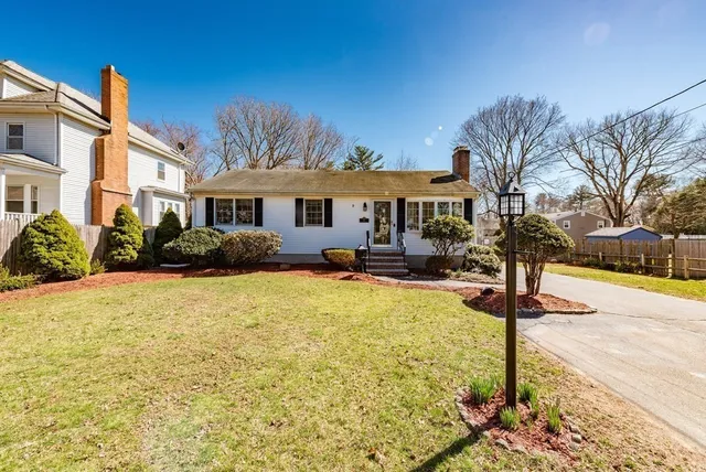 a front view of house with yard and trees
