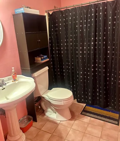 a bathroom with a sink toilet and mirror