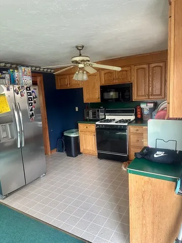 a kitchen with stainless steel appliances a stove a microwave and a refrigerator