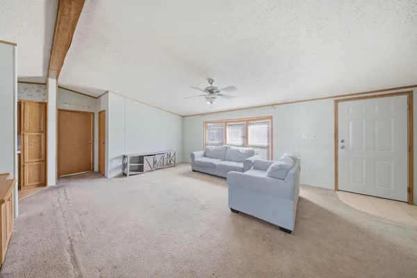 a living room with furniture and a ceiling fan