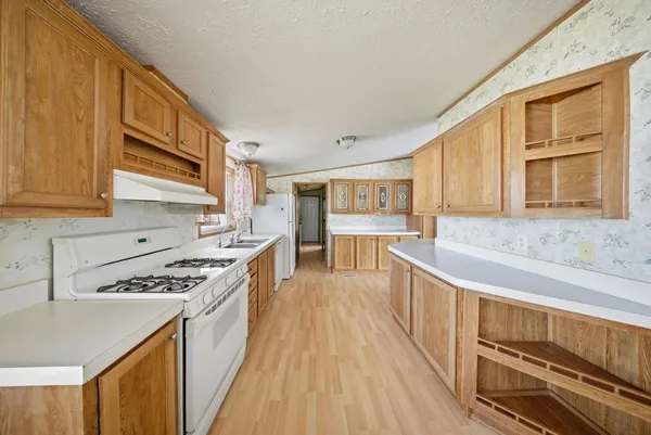 a kitchen with stainless steel appliances granite countertop a stove and a sink