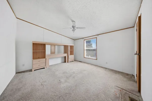 an empty room with windows and closet
