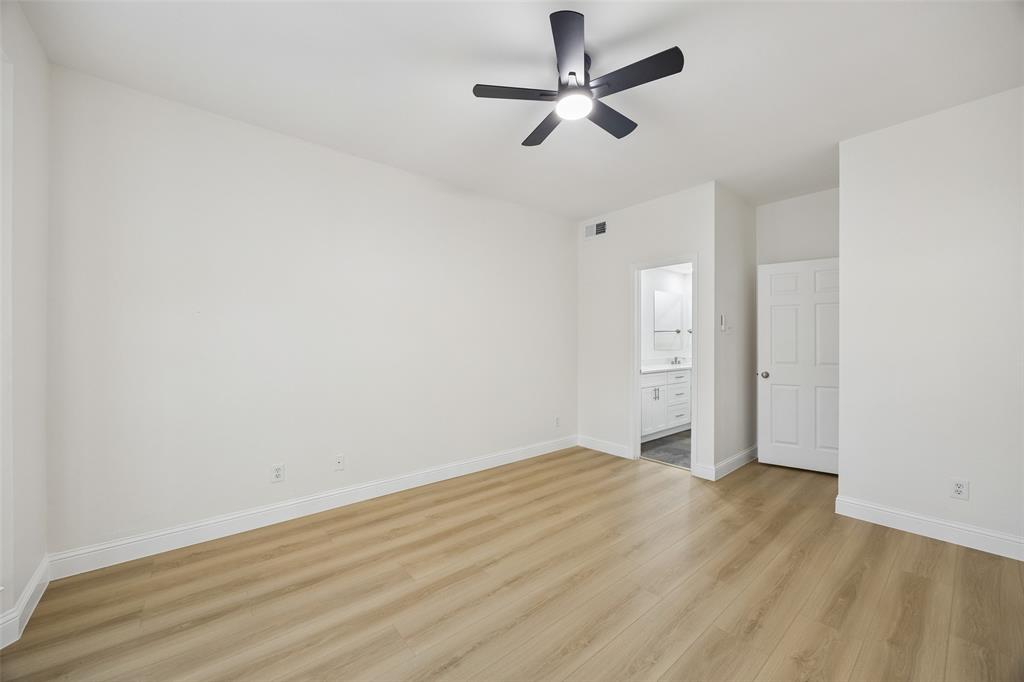 12660 Hillcrest Road, Unit 7205 Dallas, TX 75230 - Photo 5 of 25 Spacious room featuring wood-finish flooring, a modern ceiling fan with integrated lighting, and crisp white walls