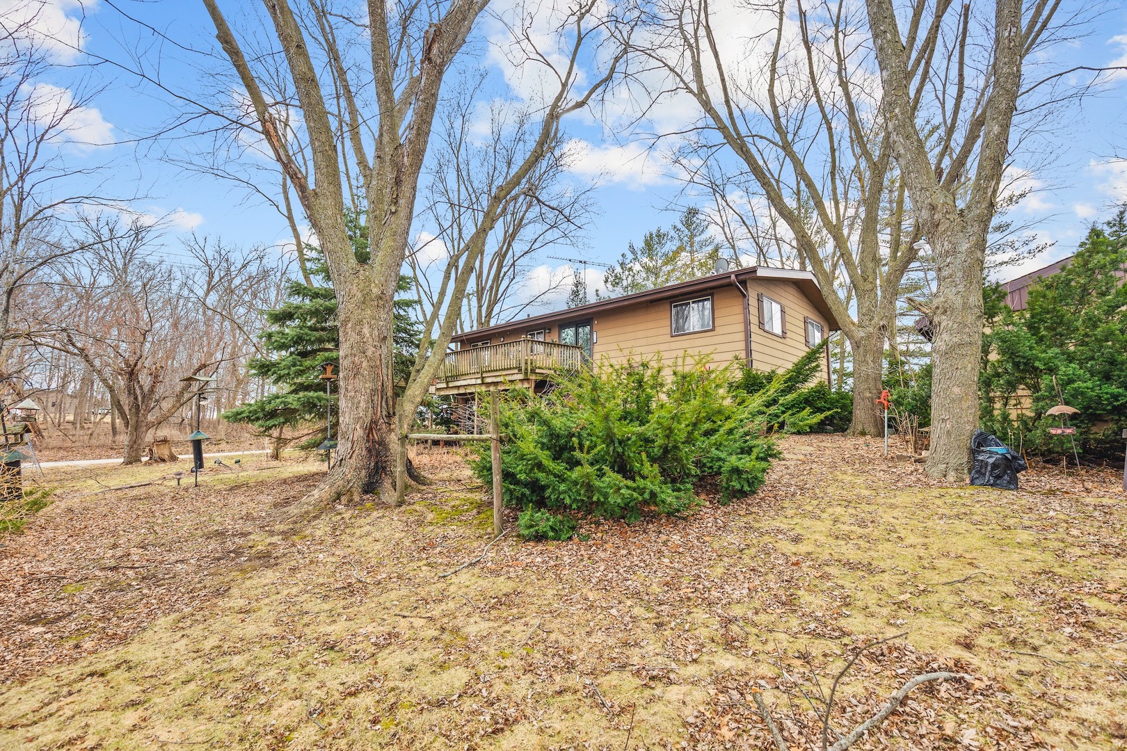 6867 North Eggert Road Rock City, IL 61070 - Photo 16 of 16 a backyard of a house with large trees and outdoor seating