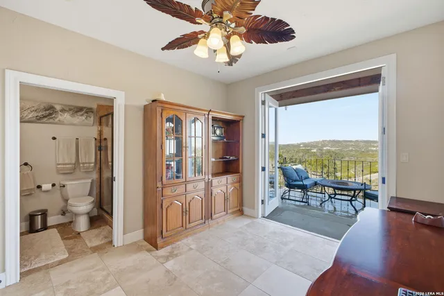 a living room with furniture and a floor to ceiling window