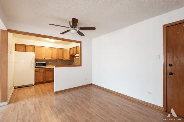 a kitchen with a refrigerator and a stove top oven