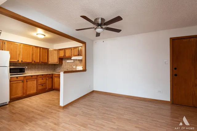 a kitchen with stainless steel appliances granite countertop a refrigerator and a stove top oven