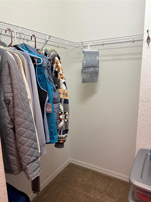 18970 Southwest 99th Street Dunnellon, FL 34432 - Photo 11 of 52 a view of walk in closet with clothes and shoes