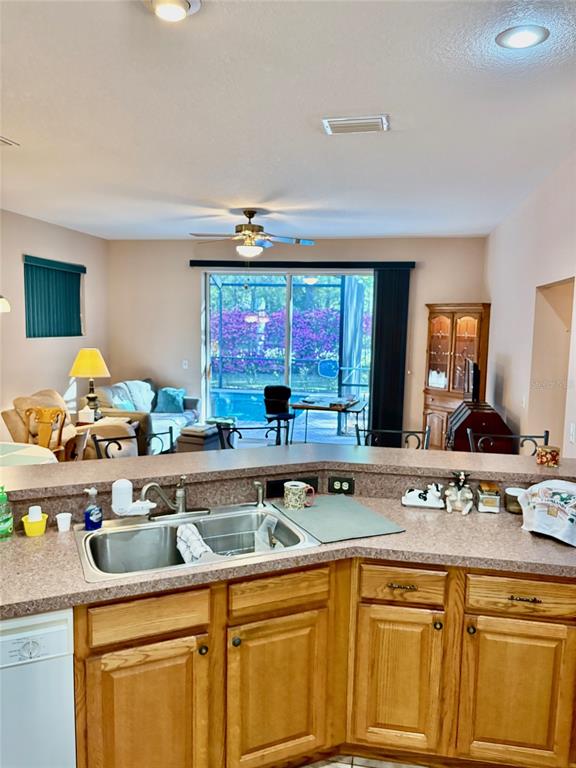 18970 Southwest 99th Street Dunnellon, FL 34432 - Photo 20 of 52 a kitchen with sink stove and cabinets
