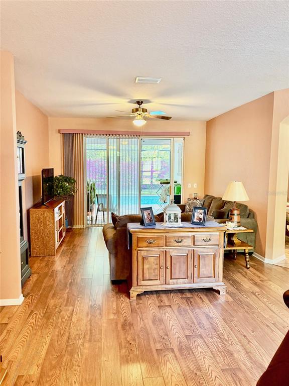 18970 Southwest 99th Street Dunnellon, FL 34432 - Photo 2 of 52 a living room with furniture and large windows