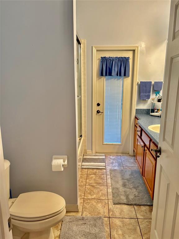 18970 Southwest 99th Street Dunnellon, FL 34432 - Photo 26 of 52 a bathroom with a granite countertop shower and a toilet